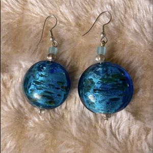 Blue glasslike bead earrings; round.
